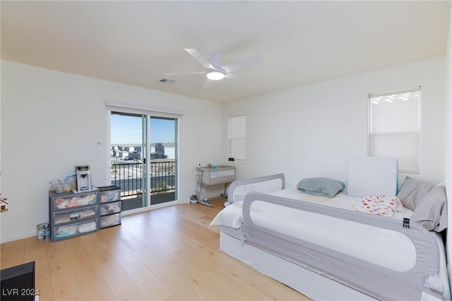 bedroom featuring ceiling fan, light hardwood / wood-style floors, and access to outside