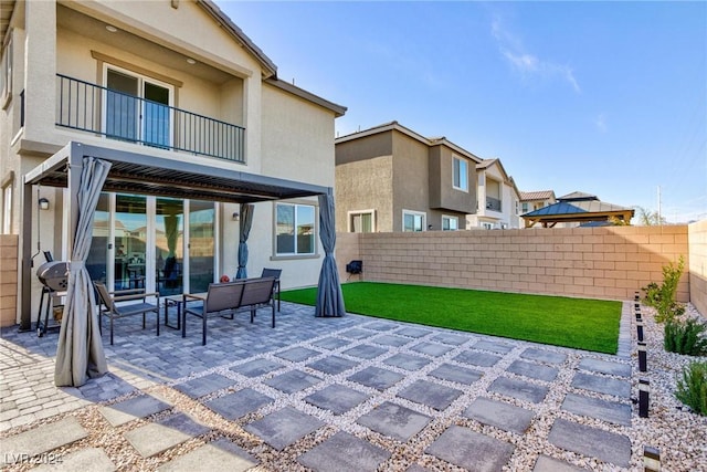 view of patio with outdoor lounge area and a balcony