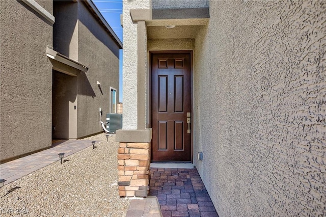 entrance to property featuring central air condition unit