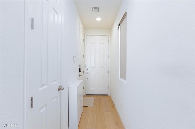 corridor with light hardwood / wood-style flooring