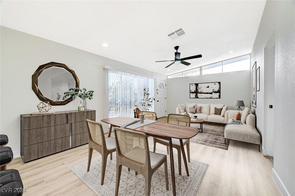 dining area with ceiling fan, plenty of natural light, lofted ceiling, and light hardwood / wood-style flooring