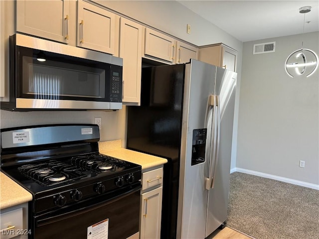 kitchen featuring stainless steel appliances and decorative light fixtures