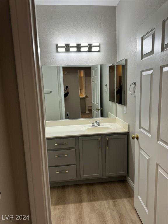 bathroom featuring vanity and hardwood / wood-style flooring