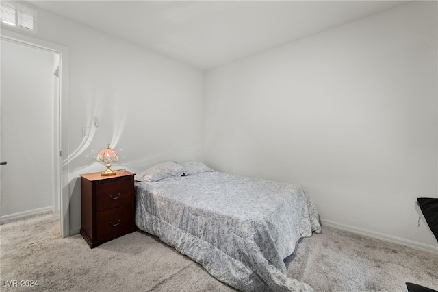 bedroom with light colored carpet