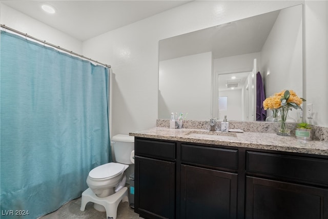 bathroom featuring vanity and toilet