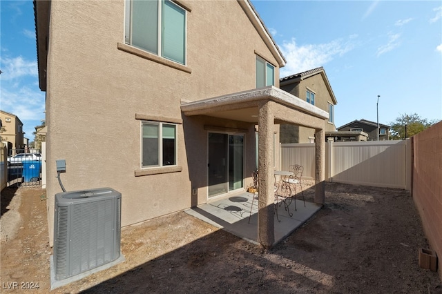 back of house featuring central AC and a patio area