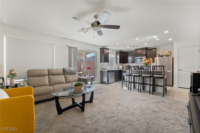 living room featuring light carpet and ceiling fan