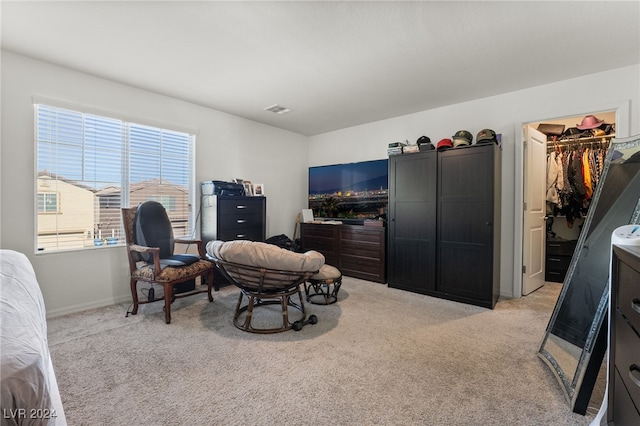 sitting room featuring light carpet