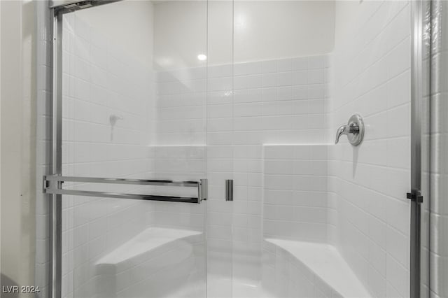 bathroom with a shower with shower door