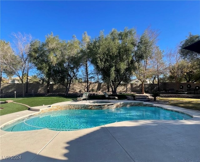 view of swimming pool with a lawn, a patio, and an in ground hot tub