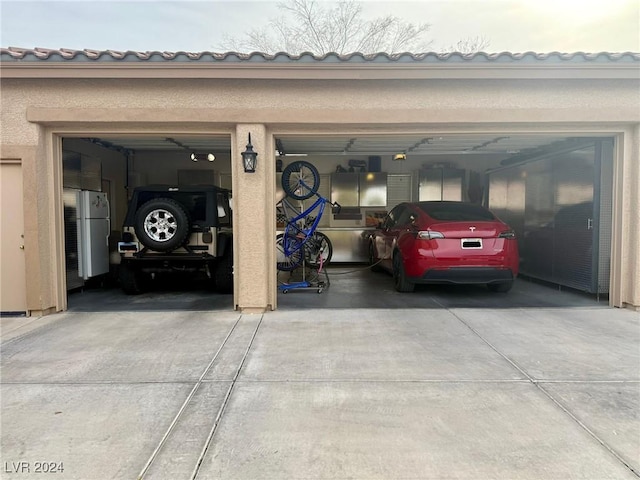 garage featuring white fridge