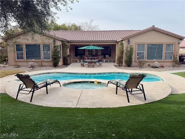 view of pool with a yard, a patio area, an outdoor hangout area, and an in ground hot tub