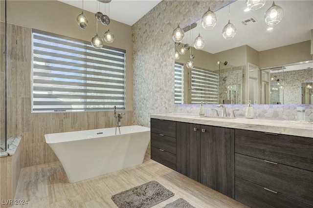 bathroom with vanity and independent shower and bath