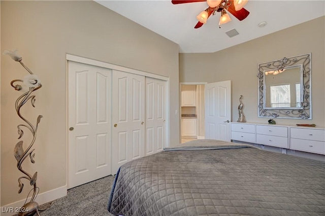 carpeted bedroom featuring ceiling fan and a closet