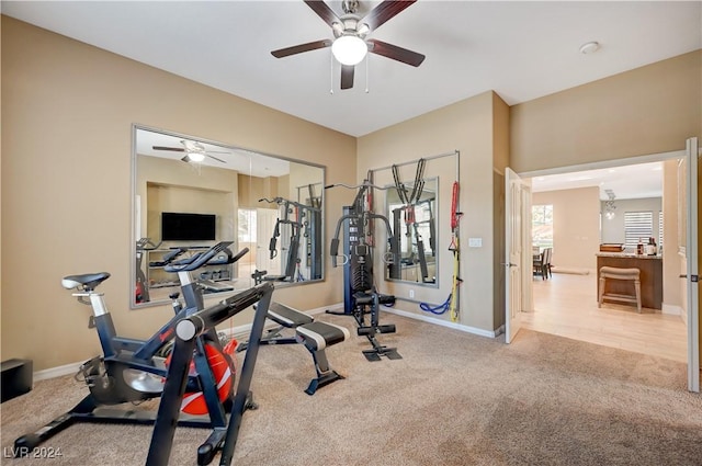 workout room featuring ceiling fan and light colored carpet