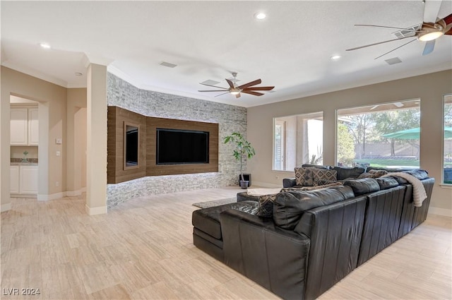 living room featuring ceiling fan, ornamental molding, and light hardwood / wood-style floors