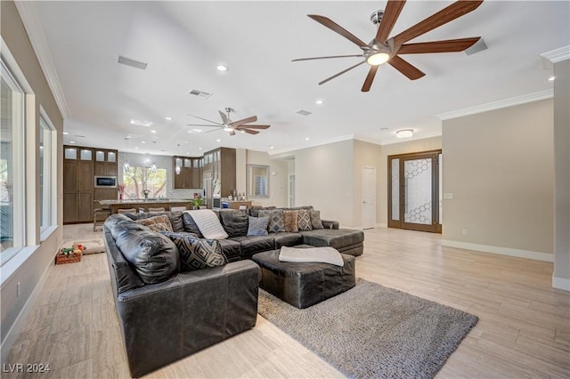 living room featuring crown molding, ceiling fan, and light wood-type flooring