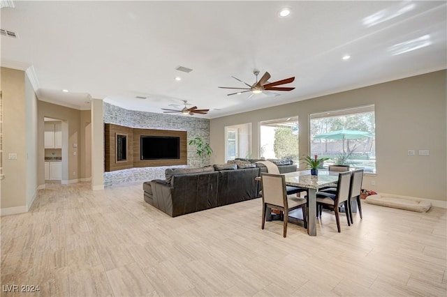 dining space featuring light hardwood / wood-style flooring, ornamental molding, and ceiling fan