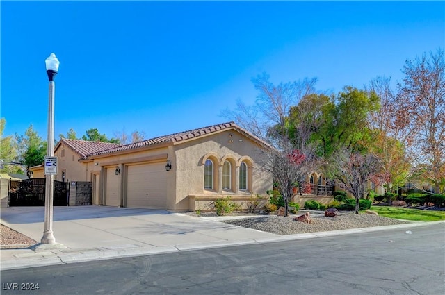 mediterranean / spanish-style house with a garage