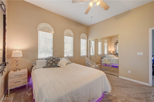 bedroom with carpet, lofted ceiling, ceiling fan, and a closet