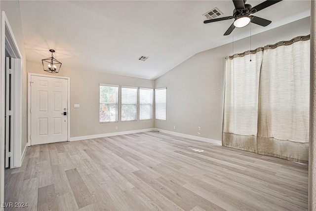 entryway with ceiling fan with notable chandelier, lofted ceiling, and light hardwood / wood-style flooring