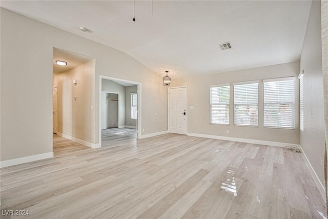 unfurnished living room with light hardwood / wood-style flooring and lofted ceiling