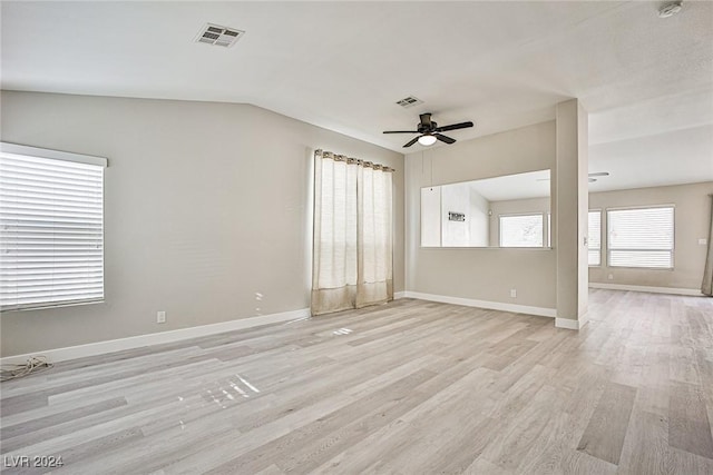 empty room featuring ceiling fan, lofted ceiling, and light wood-type flooring