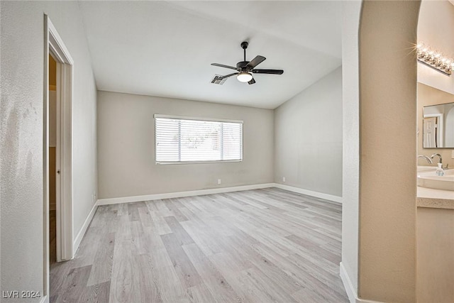 empty room with ceiling fan, sink, and light hardwood / wood-style floors