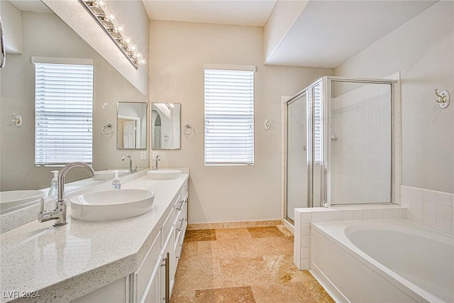 bathroom featuring shower with separate bathtub and vanity