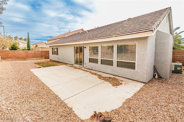 rear view of property featuring a patio area and central AC