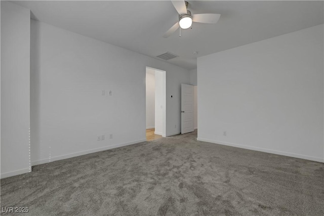 carpeted spare room with ceiling fan