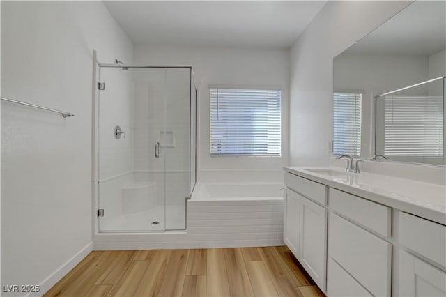 bathroom with vanity, separate shower and tub, and hardwood / wood-style floors