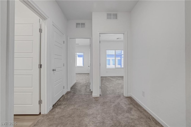 hallway with light carpet