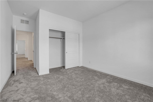 unfurnished bedroom with a closet and light carpet