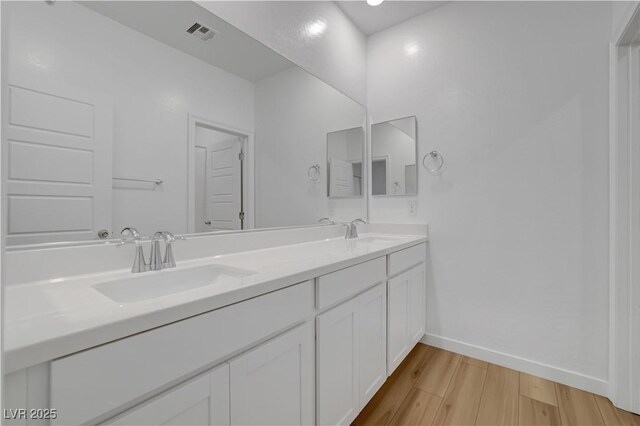 bathroom with vanity and hardwood / wood-style flooring