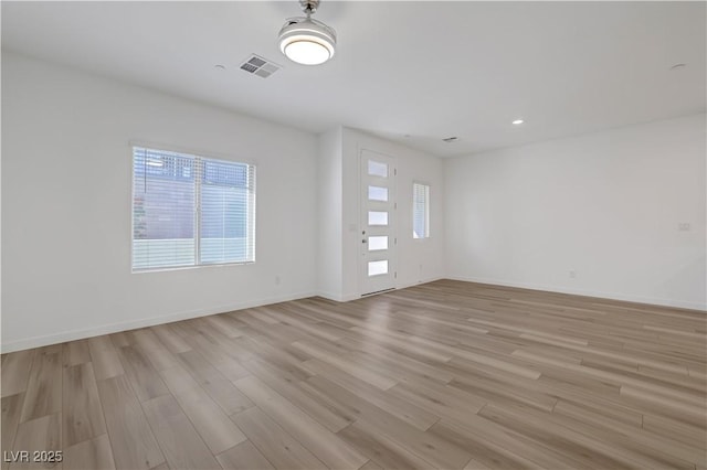 spare room featuring light hardwood / wood-style flooring