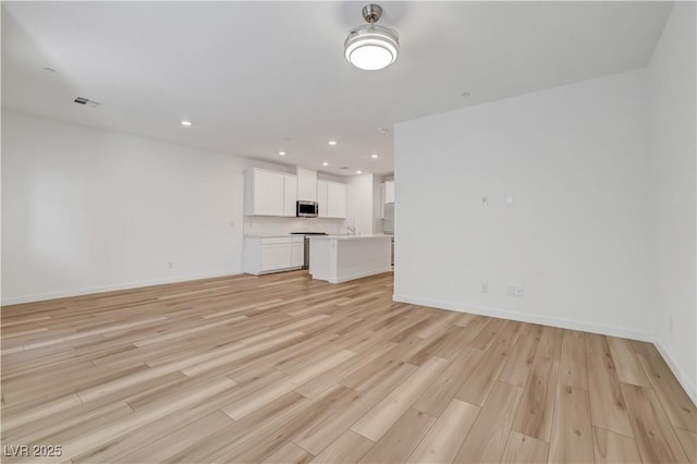 unfurnished living room with light hardwood / wood-style flooring