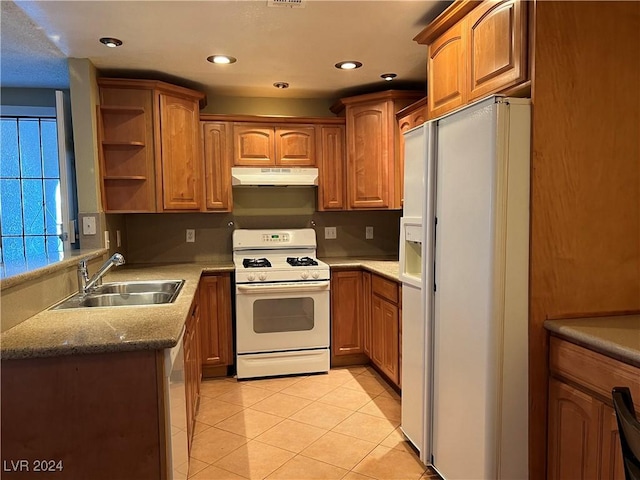 kitchen with sink, light tile patterned flooring, and white appliances