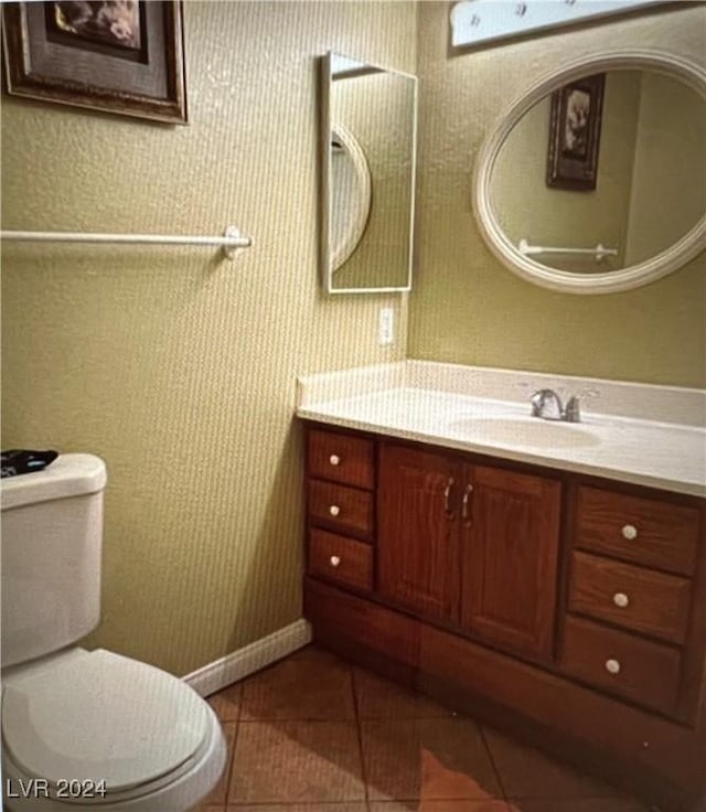 bathroom with tile patterned flooring, vanity, and toilet