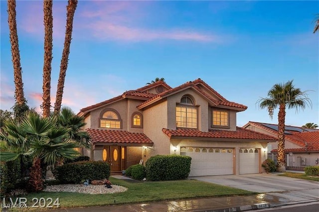 mediterranean / spanish-style house featuring a garage