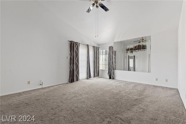 spare room featuring ceiling fan, carpet floors, and high vaulted ceiling