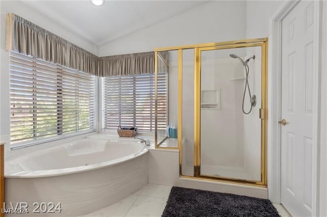 bathroom featuring independent shower and bath and lofted ceiling