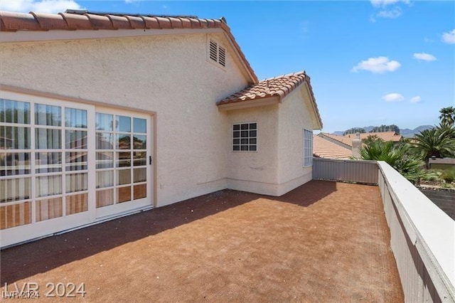 back of property featuring a balcony