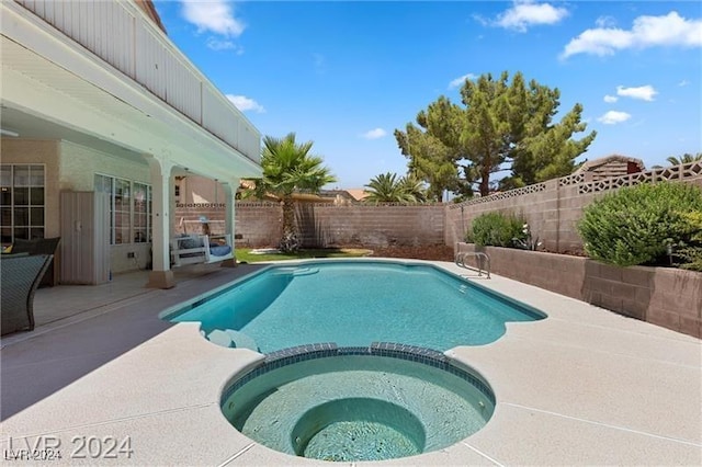 view of pool with an in ground hot tub and a patio