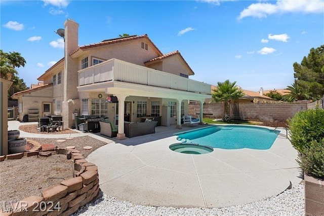 view of swimming pool featuring an in ground hot tub, a patio, and an outdoor hangout area