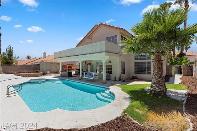 view of pool featuring a patio and a shed