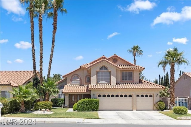 mediterranean / spanish-style house with a garage