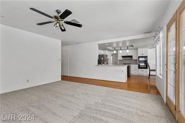 unfurnished living room with plenty of natural light and light colored carpet