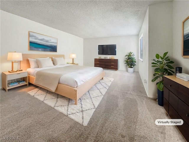 carpeted bedroom featuring a textured ceiling