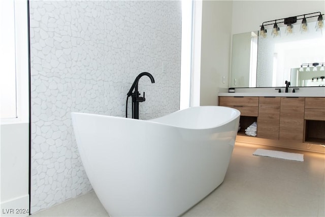 bathroom featuring concrete floors, vanity, and a bath